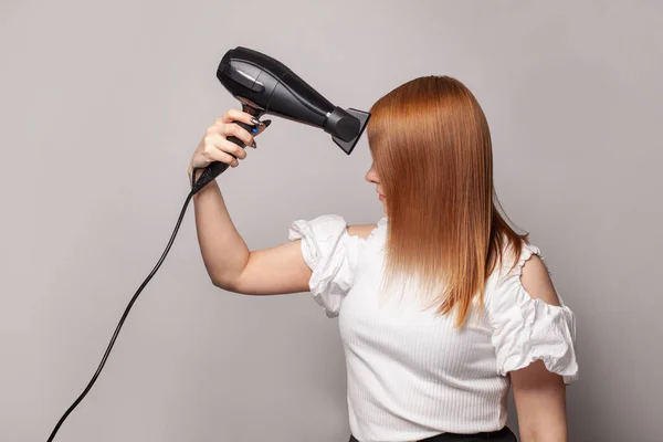 Pretty Young Woman Drying Her Red Hair Dryer Gray Background — Stock Photo, Image