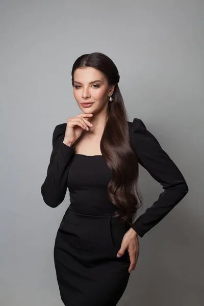 Czarujący Model Brunetka Eleganckiej Czarnej Sukience Stojącej Białym Tle — Zdjęcie stockowe