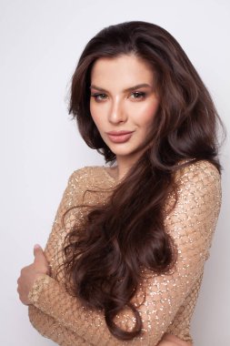 Beautiful cute woman brunette with long wavy hair closeup portrait