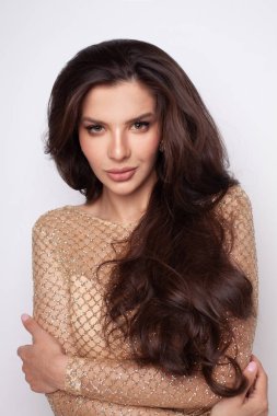 Attractive young glamorous brunette model woman with long wavy hairstyle closeup portrait