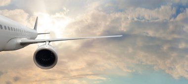 White empty commercial business airplane against blue sky and white cloud background. Transportation and travel concept