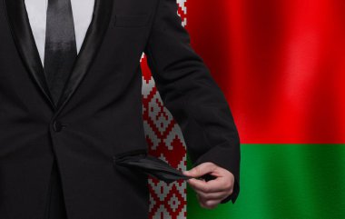 Belarusian flag background with man showing empty pockets. Financial difficulties, bad economy, no money or social problems concept.