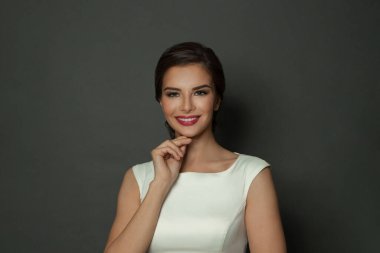 Beautiful happy smiling woman on black background, portrait