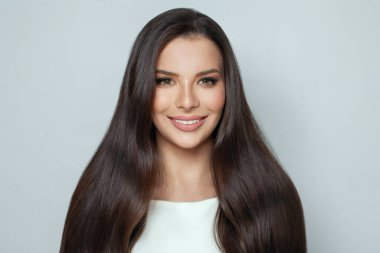 Cute good looking beautiful brunette woman with long shiny smooth straight dark hair on white background