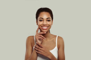 Portrait of happy attractive joyful smiling young black woman on white background