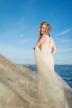 Nice model woman in light golden dress outdoors