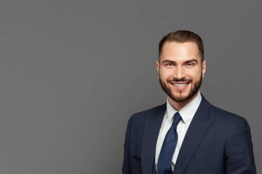 Handsome happy businessman smiling, indoor studio portrait