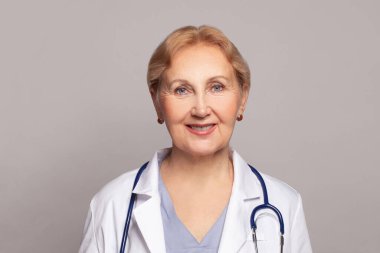 Confident friendly mature female doctor portrait