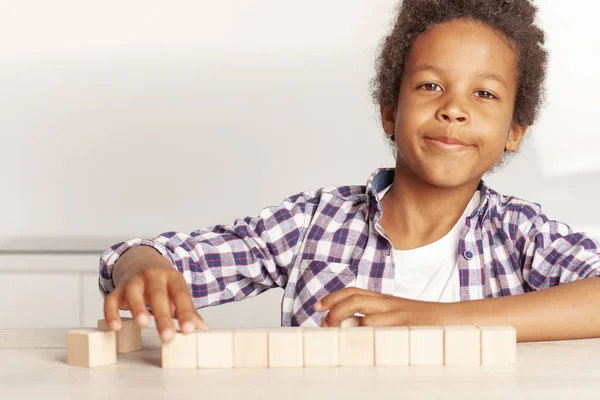 Happy preschool age child play with wooden toy blocks