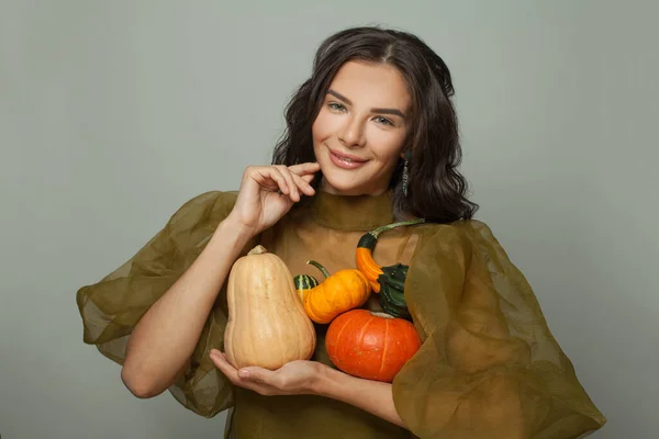 Happy woman with pumpkin on white