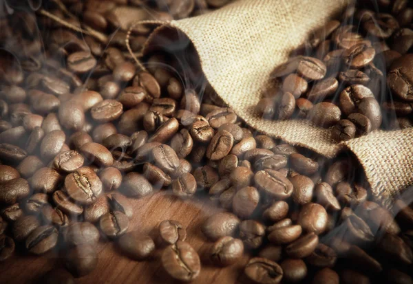 Roasted coffee beans with smoke — Stock Photo, Image