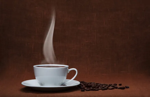 Steaming coffee with beans and copy space — Stock Photo, Image