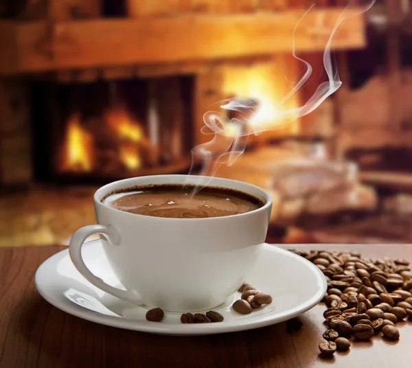 Hot coffee near fireplace — Stock Photo, Image