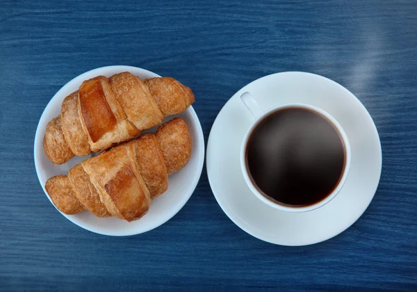 Coffee and croissants on blue — Stock Photo, Image