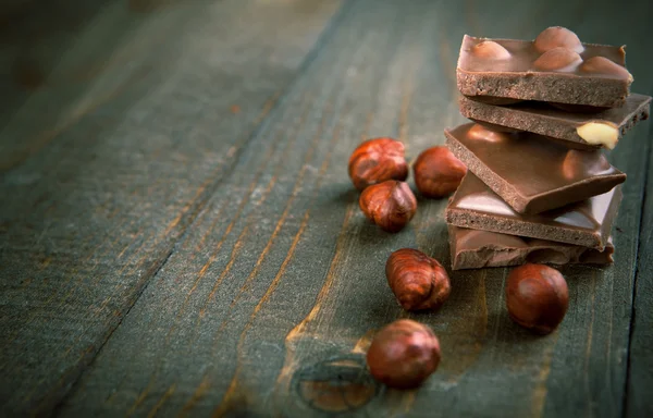Chocolate with hazelnuts - copy space — Stock Photo, Image
