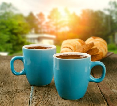 two cups of coffee in morning garden clipart