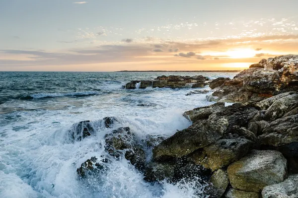 Rocky sea shore on sunset — Stock Photo, Image