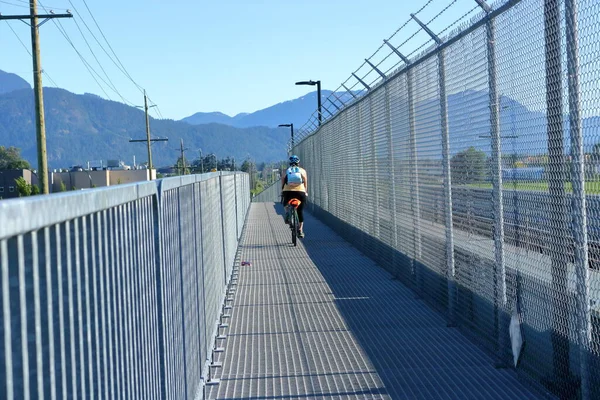 Cyclist Crosses Overpass High Fencing Barbed Wire Overpass Constructed Allow — Zdjęcie stockowe