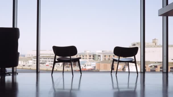 Cadeiras na janela da biblioteca com vista para o porto — Vídeo de Stock