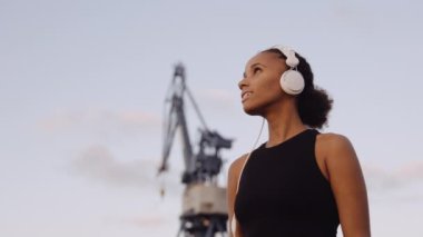 Spor Giyim 'deki kadın gün doğumuna bakıyor.