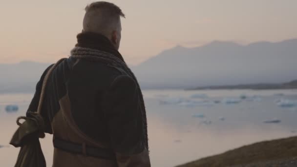 Man Walking Through Cold Sunset Landscape — Stock video