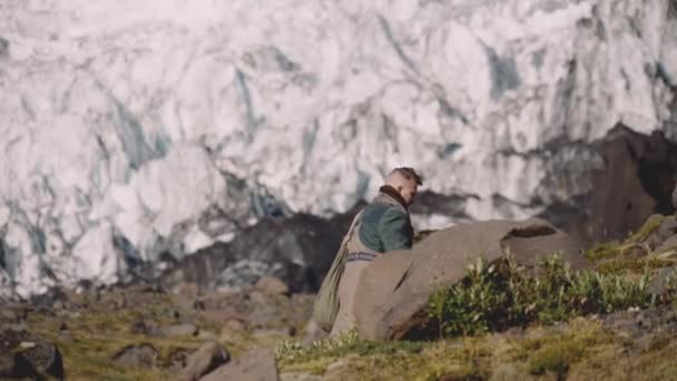 Resenär bär gitarr fall på Rocky Hill bredvid Glacier — Stockvideo