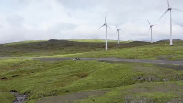 Drone Flight stiger över bilkörning längs vägen med vindkraftverk — Stockvideo
