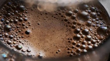 Fransız presi sıcak kahvenin içinde köpüklerin üzerine iniyor.