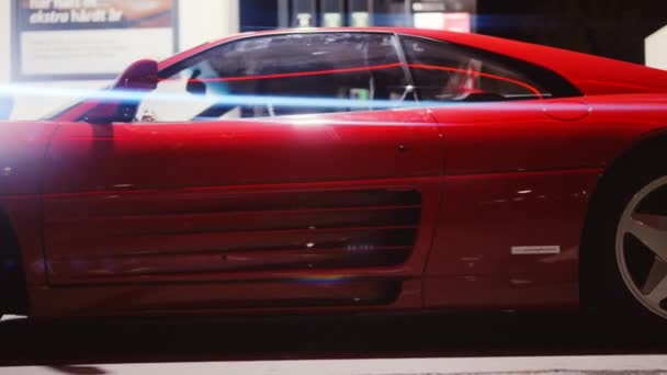 Червоний Феррарі 348 ТБ, припаркований у газовій станції вночі — стокове відео