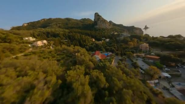 Drone Over Town Towards Rocky Outcrop At Sunset — Stock video