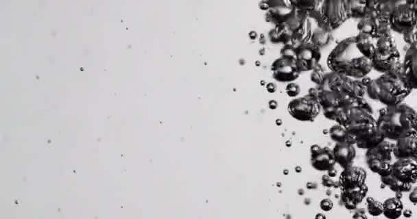 Liquid Being Poured Into Water Causing Rising Bubbles — Vídeo de Stock