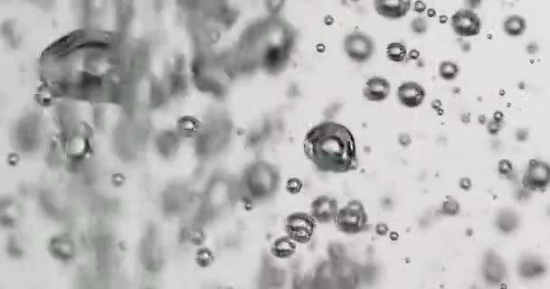 Liquid Being Poured Into Water Causing Rising Bubbles — Vídeo de Stock