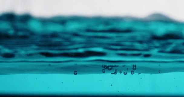 Blue Water Surface Moving Up And Down Against White Background — Video Stock