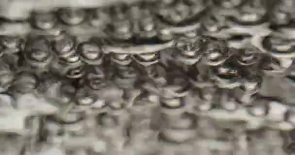 Bubbles Rising To A Moving Surface Of Water And Popping — Stockvideo