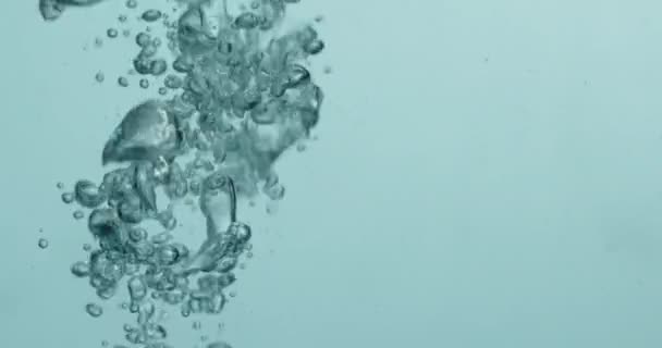 Liquid Being Poured Into Water Creating Rising Bubbles — Vídeo de Stock