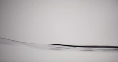 Su yüzeyi beyaz arka planda yukarı aşağı hareket ediyor