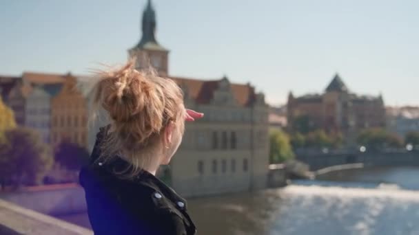 Woman Shielding Eyes From Sun As She View River From Charles Bridge — 图库视频影像