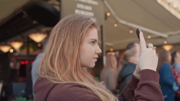 Jeune femme filmant avec un smartphone sur la place de la ville de Prague — Video