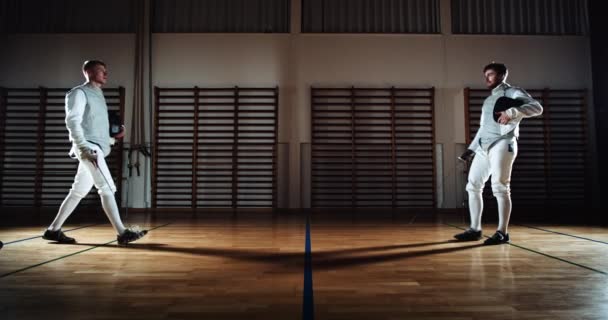 Duelling Fencers In School Gym Kissing Swords Before Fighting — Stock Video