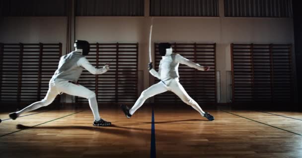 Two Men In Fencing Gear Duelling With Foils — Vídeo de Stock