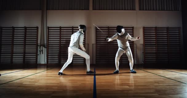 Two Men In Fencing Gear Duelling With Foils — Stockvideo