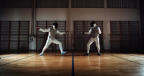 Two Men In Fencing Gear Duelling With Foils — Vídeo de Stock
