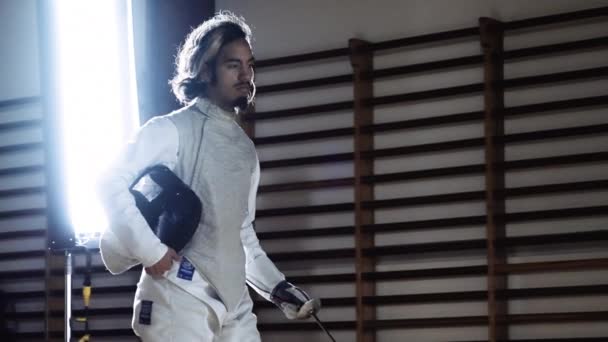 Man Walking In Fencing Gear And Holding Mask And Foil Before Duel — Stock Video