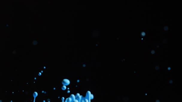 Pintura azul brillante salpicando con gotitas en el aire — Vídeo de stock