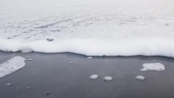 Medium Tracking Slow Motion Shot White Surf Moving Black Sand — Video Stock