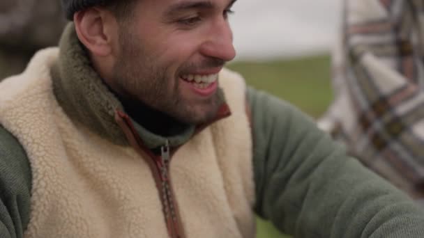 Uśmiechnięty mężczyzna w wełnianej czapce śmiejący się i patrzący w dal — Wideo stockowe