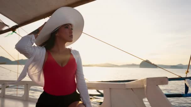 サンハットでのアウトリガーボートでリラックスした女性 — ストック動画