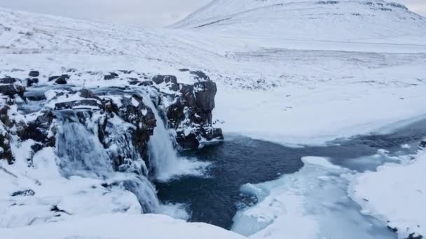 Dron nad vodopádem a zamrzlé krajiny směrem k Kirkjufell — Stock video