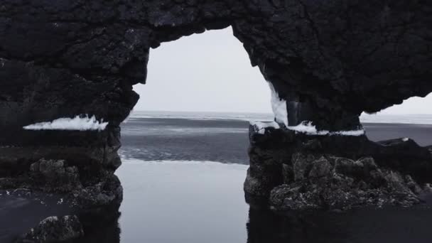 Drone Through Hvitserkur On Black Sand Beach — Video