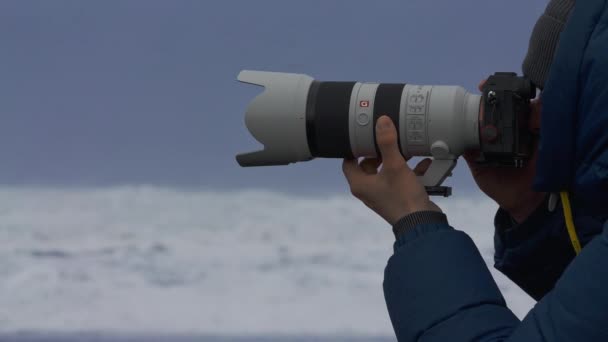 Photographer Holding Long Lens On Camera On Beach — Vídeo de stock